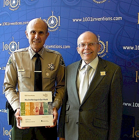 Sheriff Baca of the County of Los Angeles (left) receiving the 1001 Inventions book from Maurice Coles of 1001 Inventions and CE4tf (right).